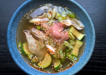 Gyoza soup with courgette, spring onions and pickled sushi ginger